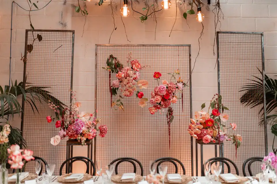 A floral archway installation in the venue's gothic style space.