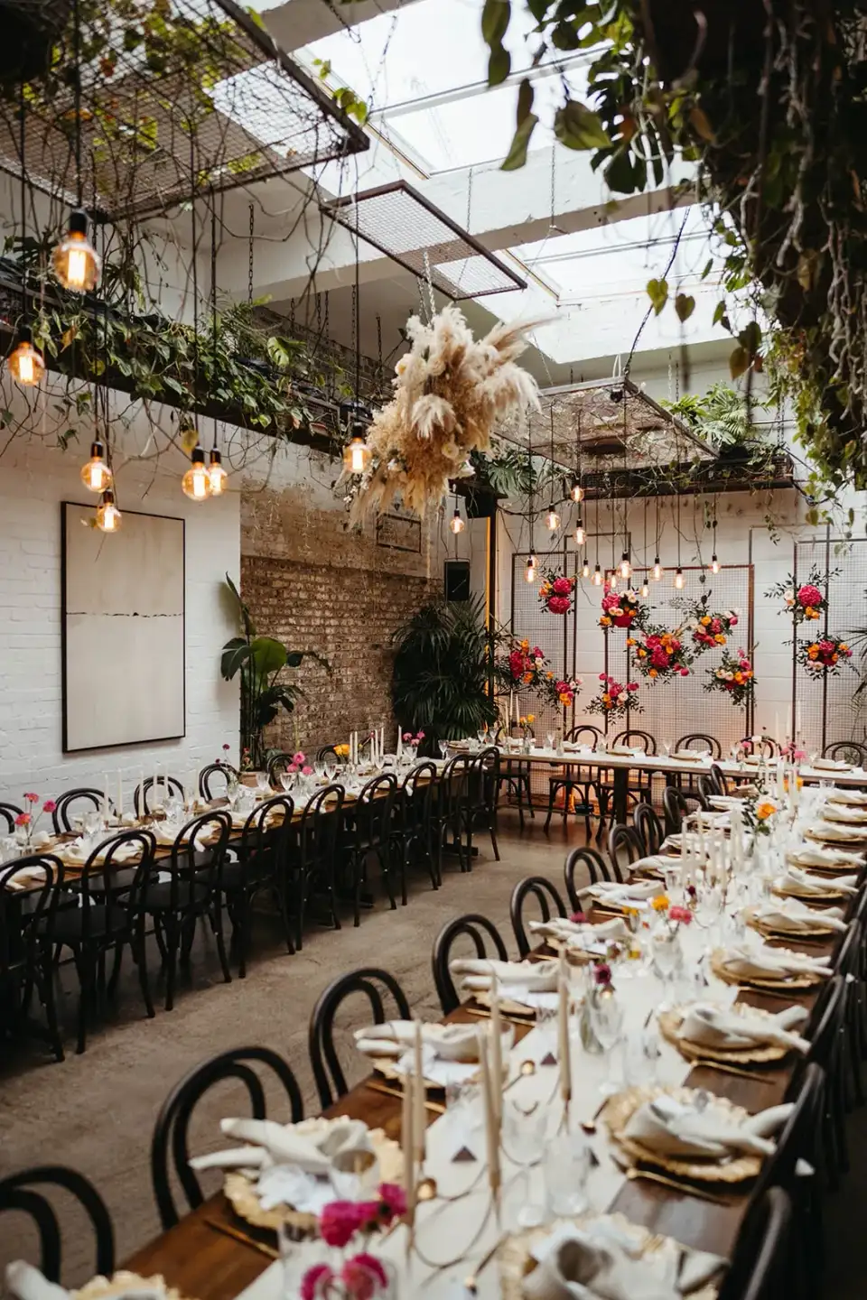 A long dinner table with a candelabra and a floral table runner.