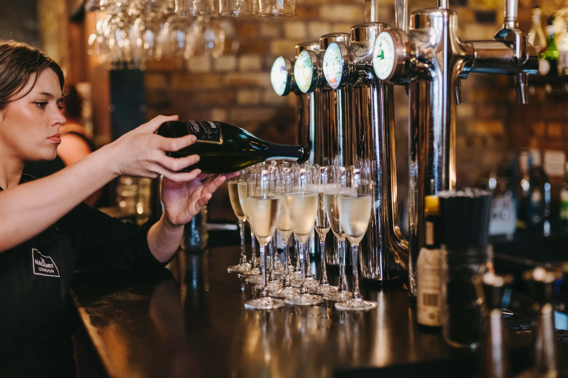 Champagne being poured at The Hackney's bar
