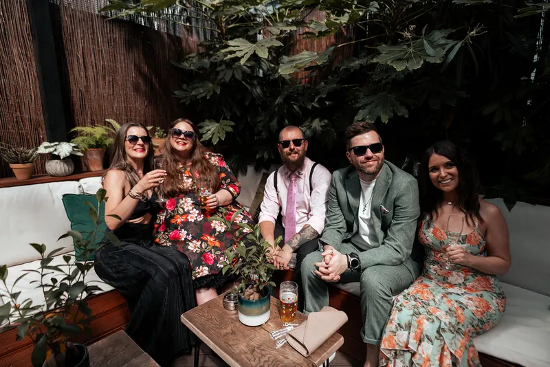 Guests enjoying sunshine on the covered terrace at The Hackney in East London
