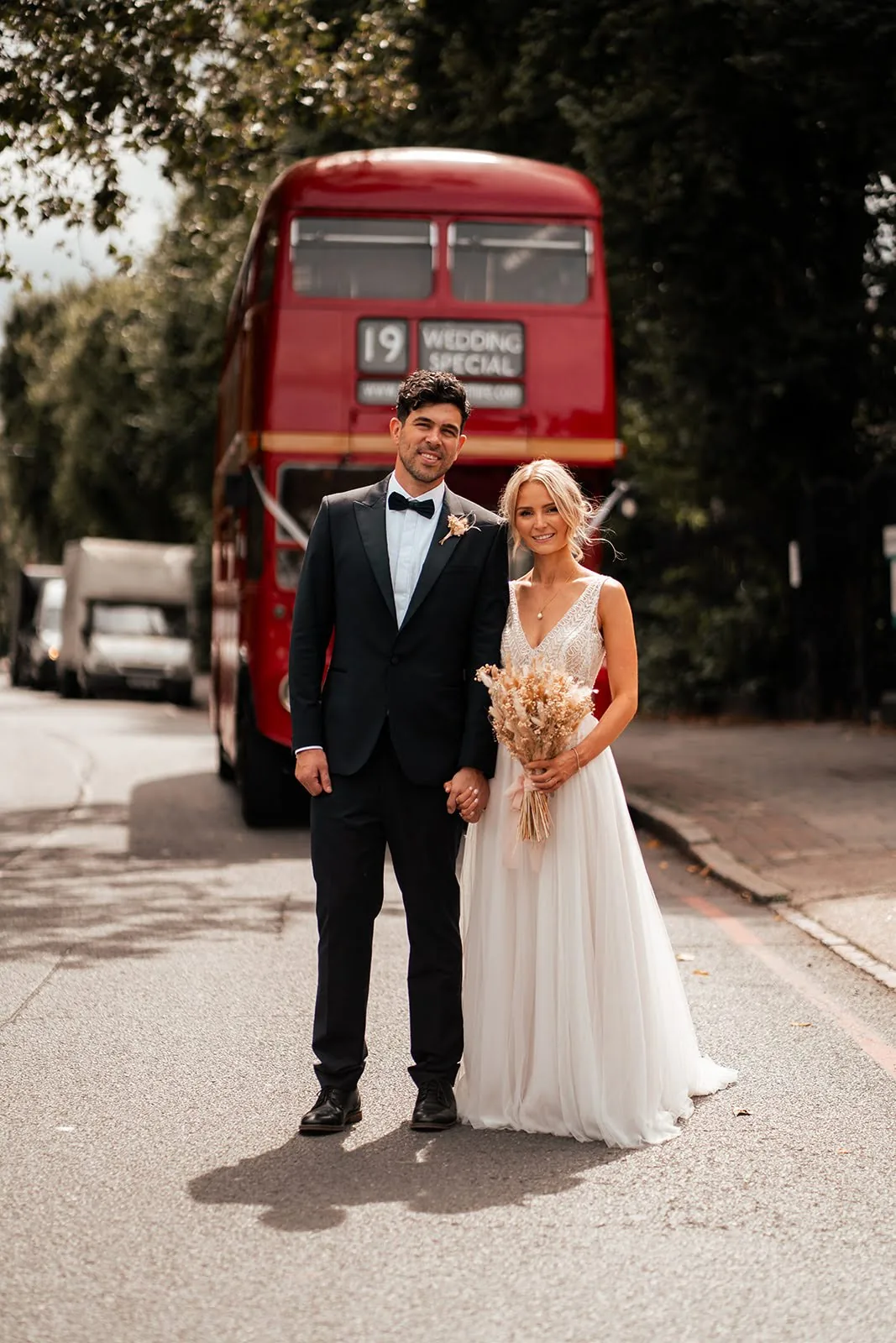 Couple aboard a vintage London bus travelling between their ceremony and The Hackney