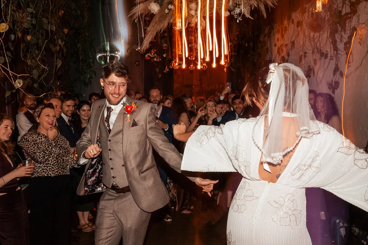 A couple dancing surrounded by guests on the dancefloor at The Hackney